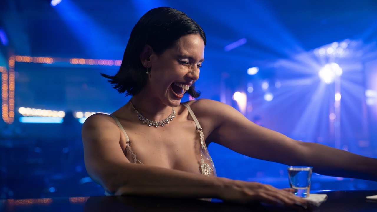 a woman laughing at a bar